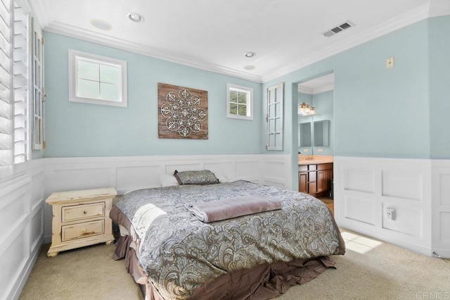 carpeted bedroom featuring visible vents, a wainscoted wall, and ornamental molding