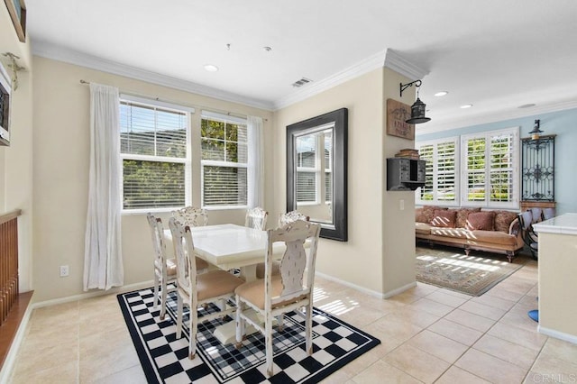 dining space featuring a wealth of natural light, visible vents, light tile patterned floors, and ornamental molding