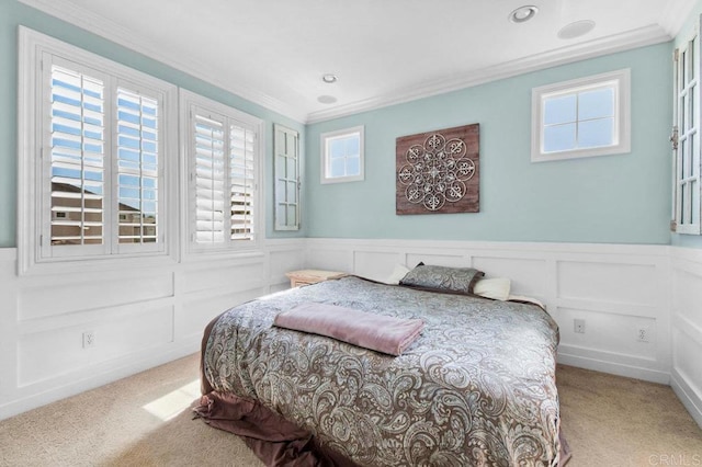 bedroom featuring recessed lighting, crown molding, a decorative wall, wainscoting, and carpet floors