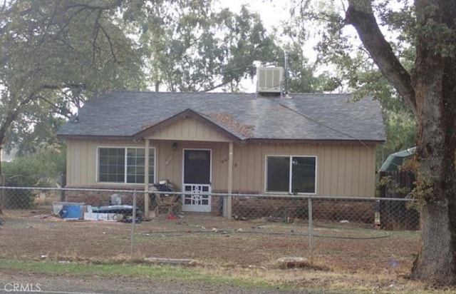view of front of house with a shingled roof and fence private yard