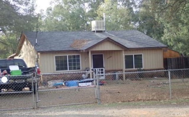 single story home featuring a gate, a fenced front yard, and roof with shingles