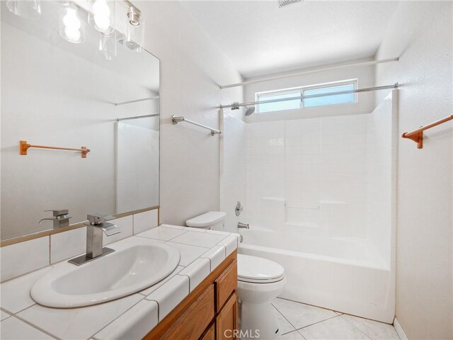 full bath featuring tile patterned floors, vanity, toilet, and bathtub / shower combination