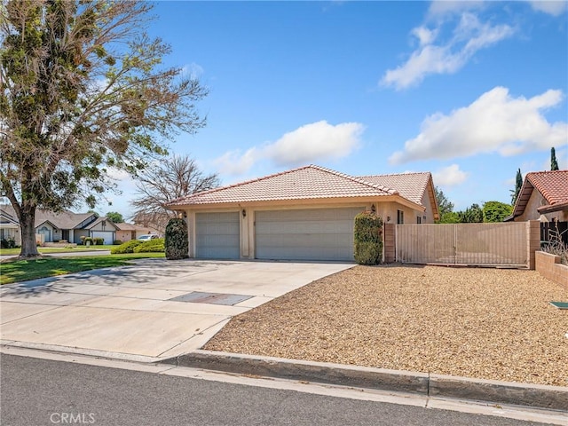ranch-style home featuring fence, stucco siding, a tiled roof, an attached garage, and driveway