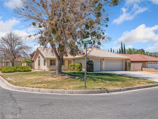 view of front of property featuring a tiled roof, a garage, fence, and stucco siding