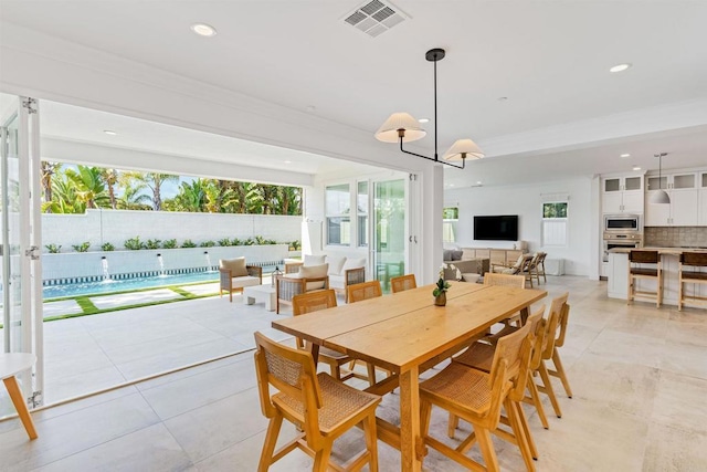 dining area with light tile patterned floors, visible vents, a healthy amount of sunlight, and recessed lighting