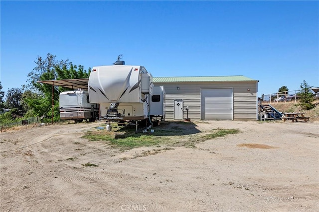 7440 Shale Rock Rd, Paso Robles, CA 93446 - rear view of property featuring a carport, an outbuilding, metal roof, and a detached garage