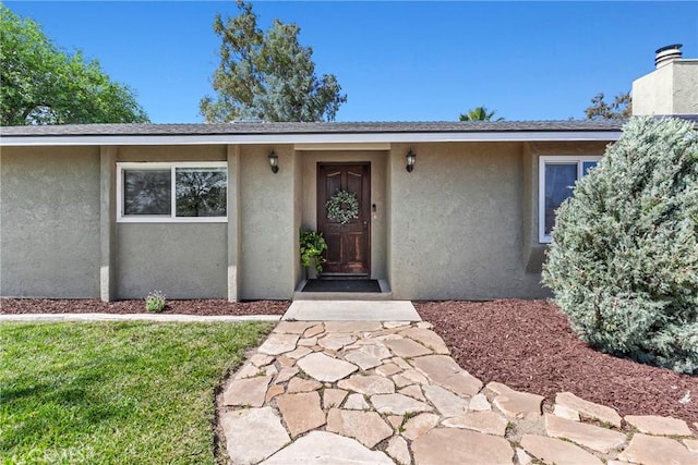 7440 Shale Rock Rd, Paso Robles, CA 93446 - view of exterior entry with stucco siding and a chimney