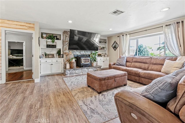 7440 Shale Rock Rd, Paso Robles, CA 93446 - living area with a wood stove, light wood-type flooring, and recessed lighting