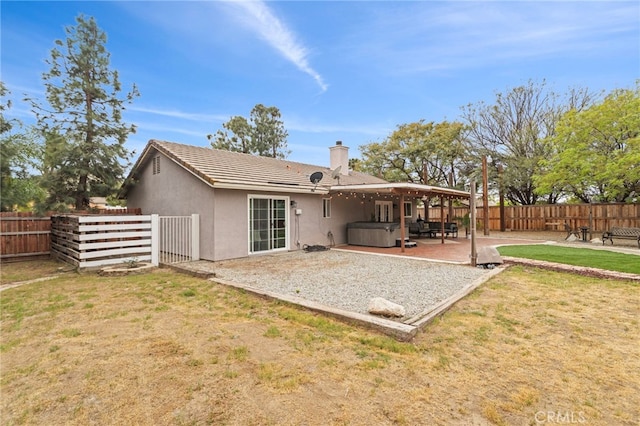 28646 Patti Ln, Menifee, CA 92585 - rear view of property featuring a hot tub, a patio area, a chimney, and stucco siding
