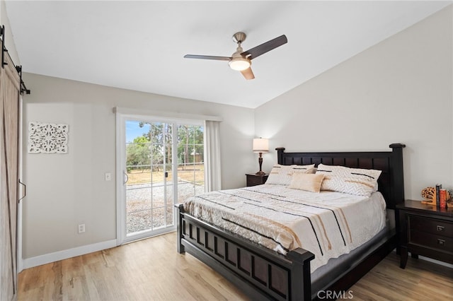 28646 Patti Ln, Menifee, CA 92585 - bedroom with access to outside, a barn door, light wood-style floors, baseboards, and vaulted ceiling