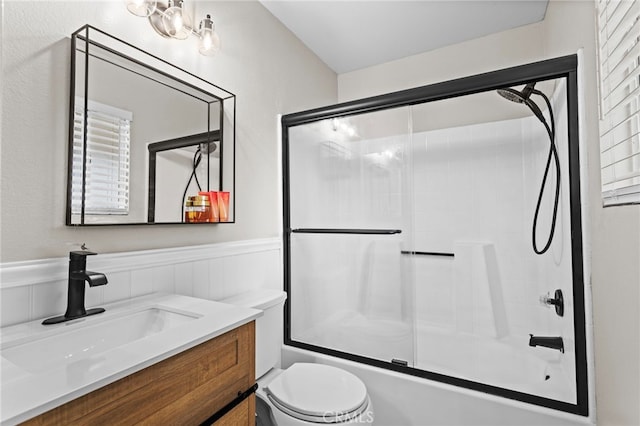 28646 Patti Ln, Menifee, CA 92585 - full bath with shower / bath combination with glass door, a wainscoted wall, vanity, and toilet