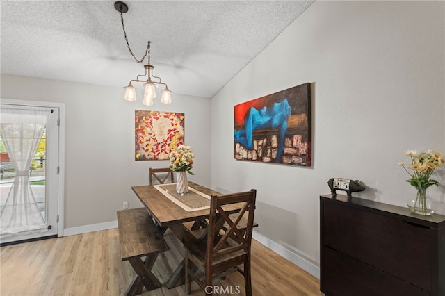 28646 Patti Ln, Menifee, CA 92585 - dining area with a textured ceiling, a chandelier, light wood-style floors, baseboards, and lofted ceiling