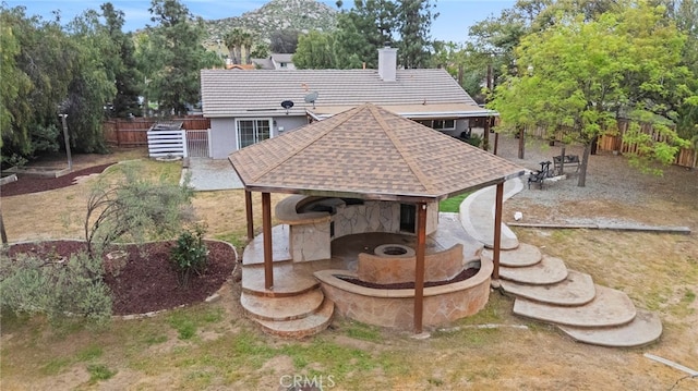 28646 Patti Ln, Menifee, CA 92585 - rear view of property featuring a chimney, a gazebo, fence, and view of wooded area