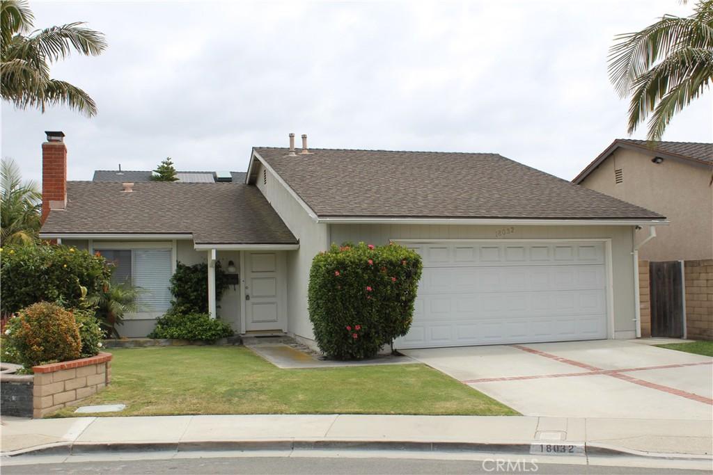 single story home with a front yard, a garage, a chimney, roof with shingles, and concrete driveway