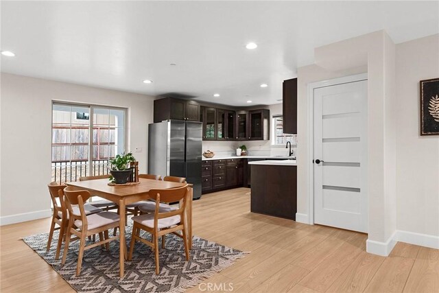 dining room featuring recessed lighting, light wood-style flooring, and baseboards