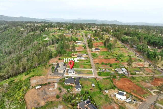 bird's eye view featuring a mountain view and a view of trees