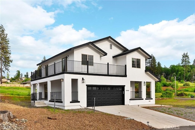 modern farmhouse style home with driveway, a garage, stucco siding, and a balcony