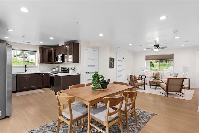 dining area with recessed lighting, a wealth of natural light, and light wood-style floors