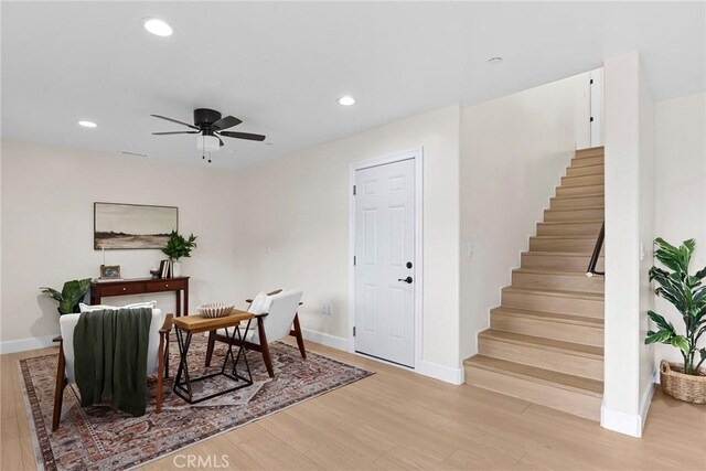 interior space featuring baseboards, recessed lighting, and light wood finished floors