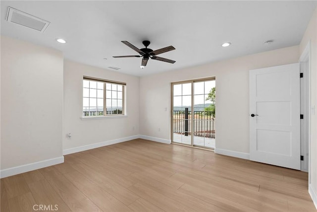 unfurnished room featuring baseboards, visible vents, and a ceiling fan