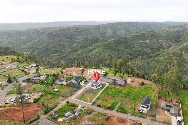 drone / aerial view with a mountain view and a forest view