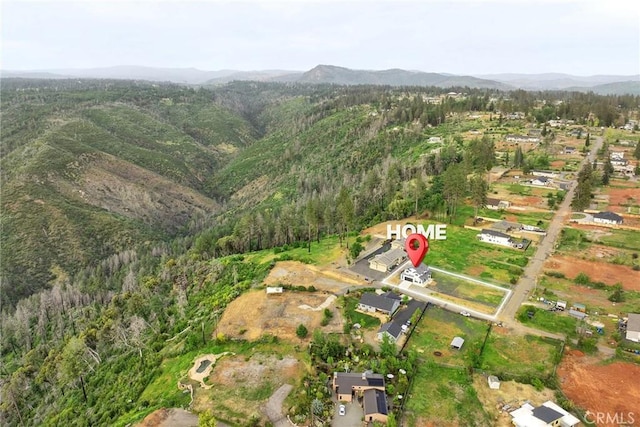 aerial view with a mountain view and a forest view