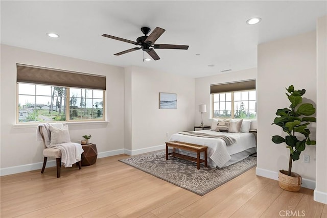 bedroom with recessed lighting, wood finished floors, and baseboards