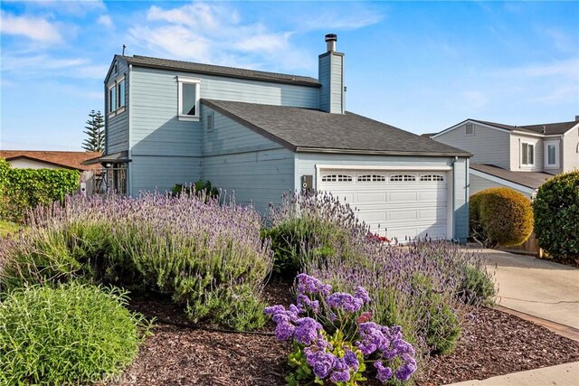 105 Joyce Way, Pismo Beach, CA 93449 - view of property exterior featuring a garage, a chimney, and driveway