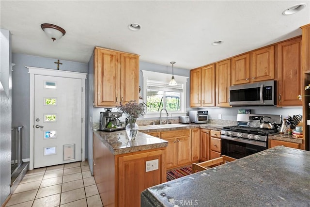 105 Joyce Way, Pismo Beach, CA 93449 - kitchen featuring appliances with stainless steel finishes, light tile patterned floors, hanging light fixtures, a peninsula, and dark countertops