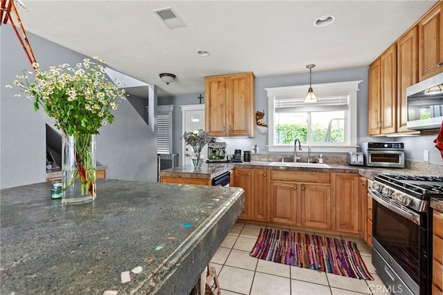 105 Joyce Way, Pismo Beach, CA 93449 - kitchen featuring appliances with stainless steel finishes, light tile patterned flooring, hanging light fixtures, brown cabinets, and recessed lighting