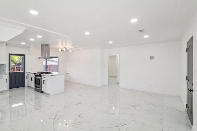 kitchen with white cabinetry, island range hood, stainless steel gas stove, open floor plan, and recessed lighting