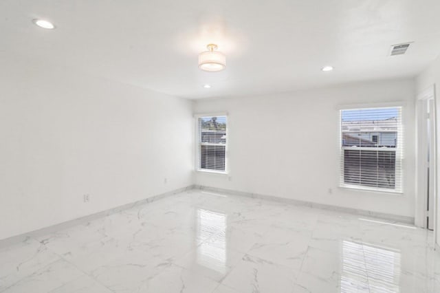 spare room featuring baseboards, visible vents, marble finish floor, and recessed lighting