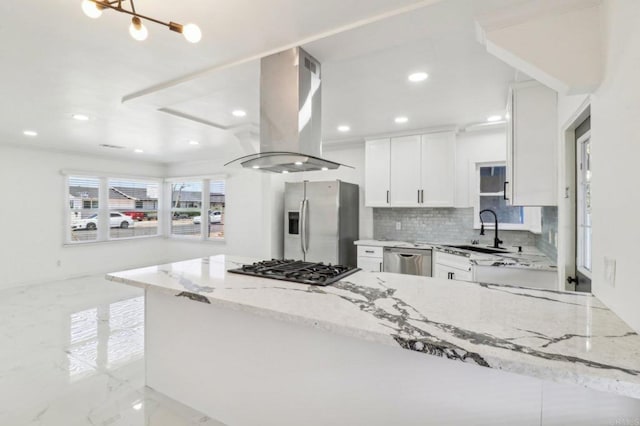 kitchen featuring a sink, stainless steel appliances, island exhaust hood, light stone counters, and white cabinets