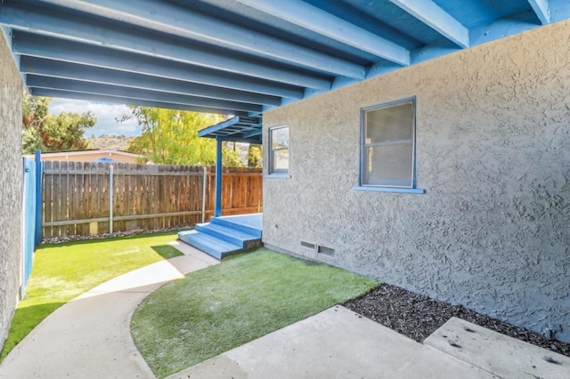 view of yard featuring fence and a patio area