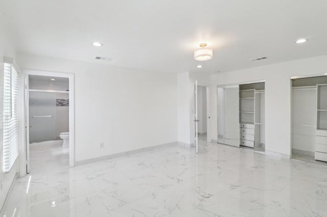 unfurnished bedroom with recessed lighting, two closets, and baseboards
