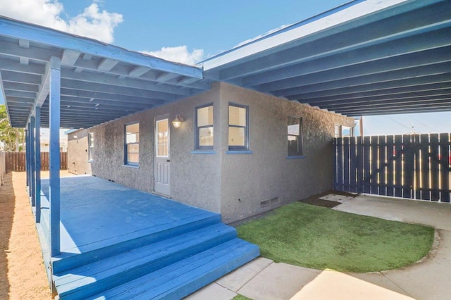 view of patio with fence and a carport