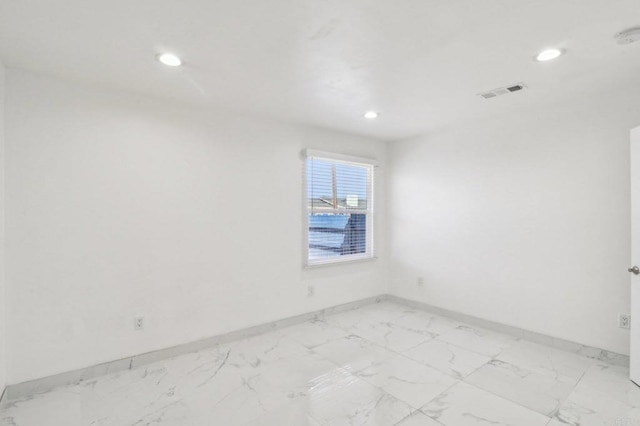 spare room featuring visible vents, recessed lighting, marble finish floor, and baseboards