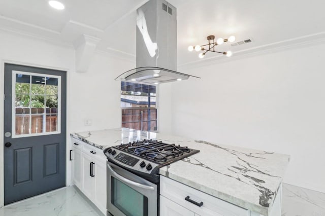 kitchen featuring stainless steel gas range, island exhaust hood, a notable chandelier, visible vents, and ornamental molding