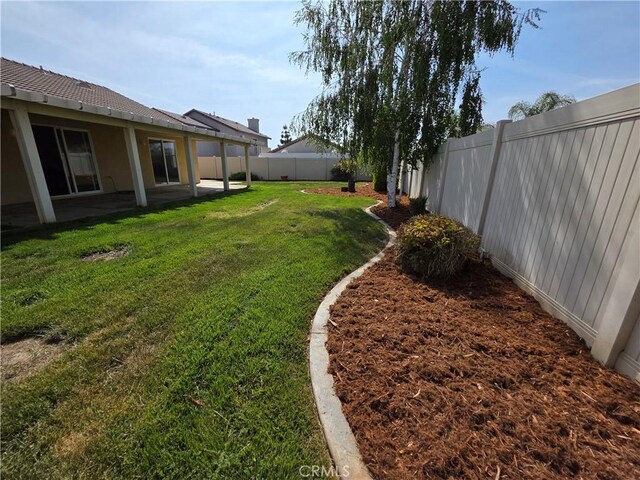 view of yard with a fenced backyard and a patio area