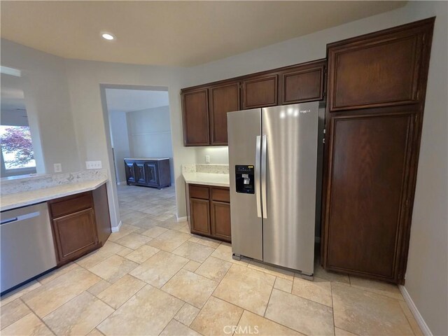 kitchen featuring appliances with stainless steel finishes, light countertops, recessed lighting, and baseboards