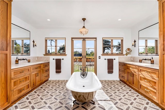 2020 N Victoria Dr, Santa Ana, CA 92706 - bathroom featuring two vanities, a soaking tub, tasteful backsplash, recessed lighting, and french doors