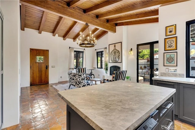 2020 N Victoria Dr, Santa Ana, CA 92706 - kitchen featuring wooden ceiling, a chandelier, plenty of natural light, beam ceiling, and decorative light fixtures