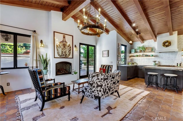 2020 N Victoria Dr, Santa Ana, CA 92706 - living area featuring wood ceiling, light stone finish flooring, beam ceiling, a chandelier, and a fireplace with raised hearth