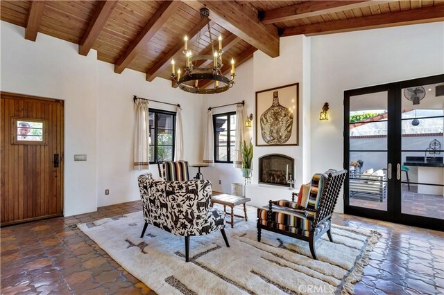 2020 N Victoria Dr, Santa Ana, CA 92706 - living area featuring wooden ceiling, a chandelier, plenty of natural light, beam ceiling, and stone finish flooring