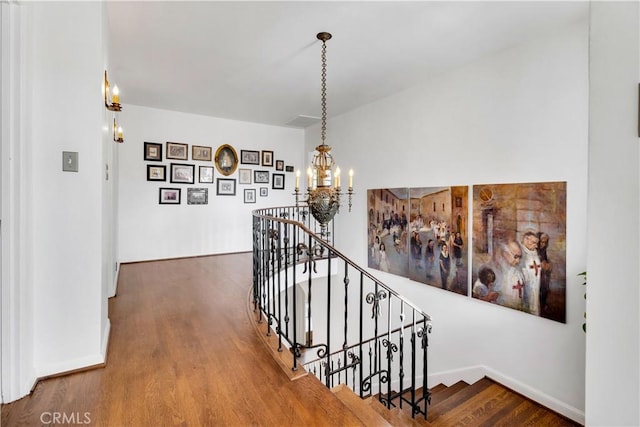 2020 N Victoria Dr, Santa Ana, CA 92706 - corridor featuring an upstairs landing, a chandelier, wood finished floors, and baseboards
