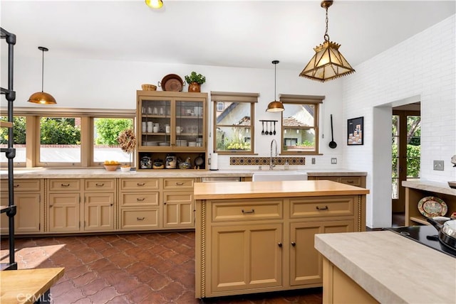 2020 N Victoria Dr, Santa Ana, CA 92706 - kitchen with a sink, glass insert cabinets, decorative light fixtures, tasteful backsplash, and a kitchen island