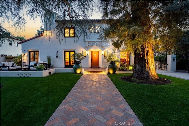 2020 N Victoria Dr, Santa Ana, CA 92706 - mediterranean / spanish-style house featuring an outdoor hangout area, a front yard, french doors, and stucco siding