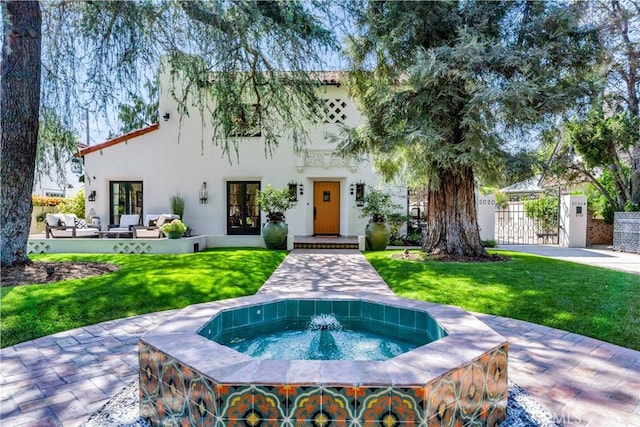 2020 N Victoria Dr, Santa Ana, CA 92706 - view of front of home with stucco siding, french doors, a gate, and an outdoor hangout area