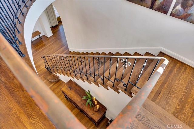 2020 N Victoria Dr, Santa Ana, CA 92706 - staircase featuring wood finished floors, baseboards, and arched walkways