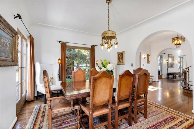 2020 N Victoria Dr, Santa Ana, CA 92706 - dining space with arched walkways, a chandelier, and wood finished floors